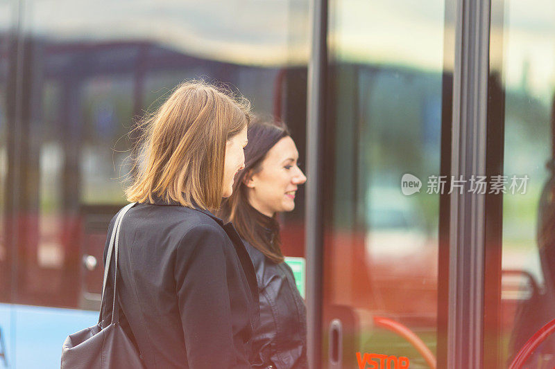 Young women waiting on the bus station